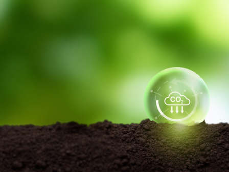 Reduction of carbon emissions, carbon neutral concept. Net zero greenhouse gas emissions target. Reducing carbon footprint concept. Decreasing CO2 emissions target symbol on green view background.