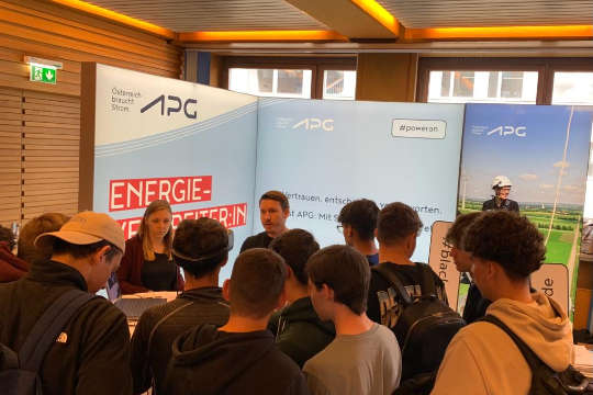 Eine Menschentraube vor einem APG-Messestand.