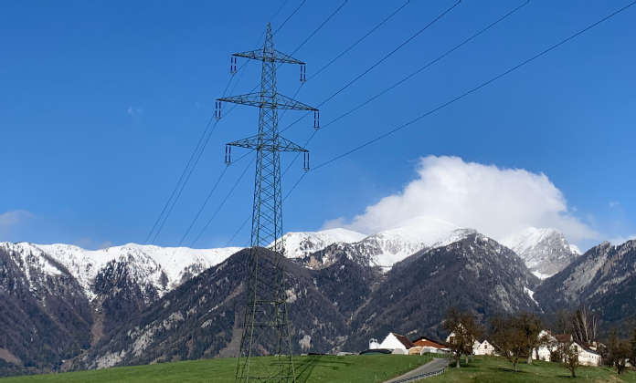 Image of a 220-kV power line with mountains in the background